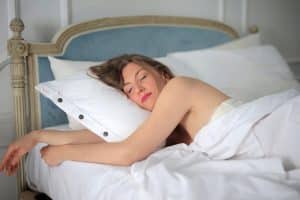 Young female sleeping peacefully in the bed in the morning